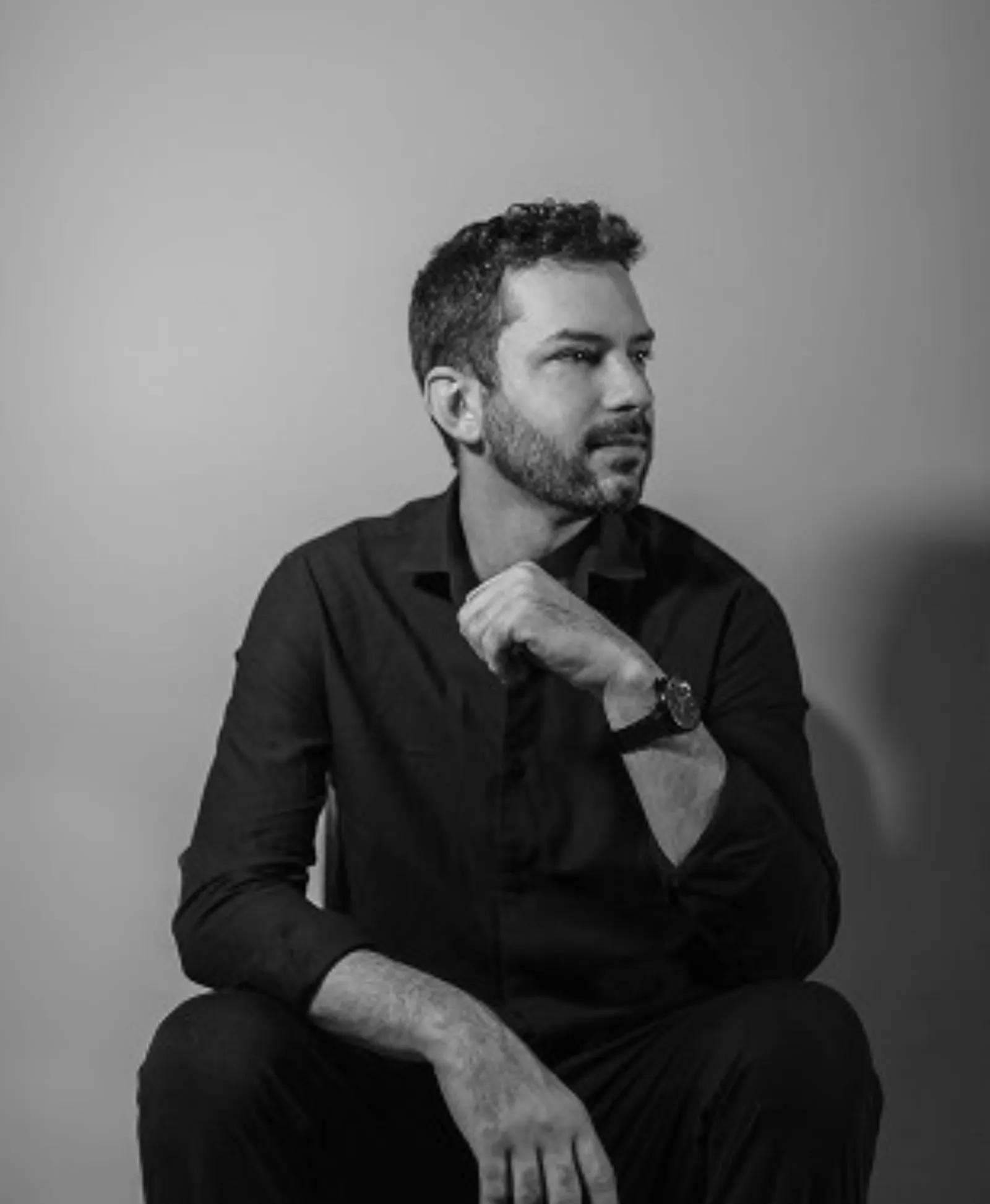 Retrato de homem sentado em preto e branco